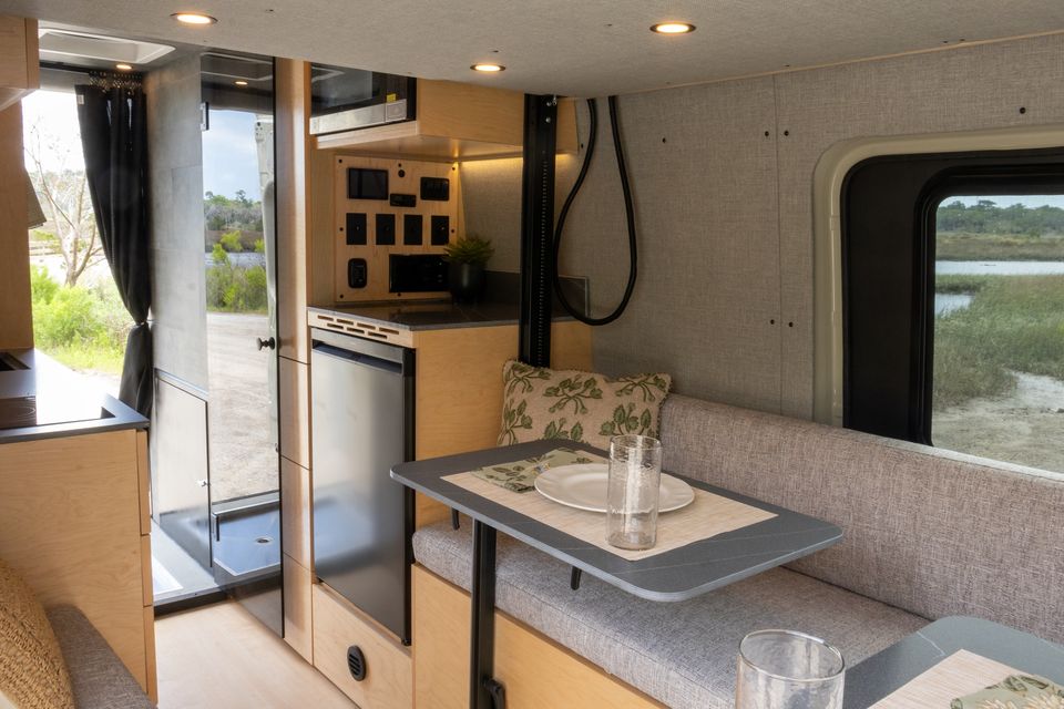 The Oasis lounge with a set table, upholstered bench and maple cabinetry