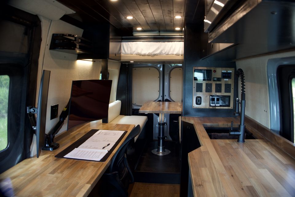 The Gamer Van desk workstation, galley kitchen and rear elevator bed